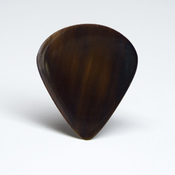 The Flunder series custom buffalo horn guitar pick is a thin but stiff plectrum with  highly polished body and edges and a very distinct tortoise shell like sound and feel.